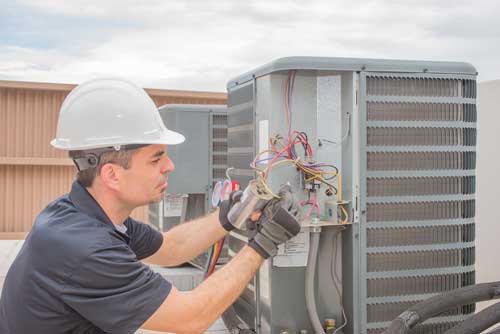 A contractor works on an hvac system