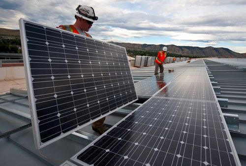Workers install a solar energy system